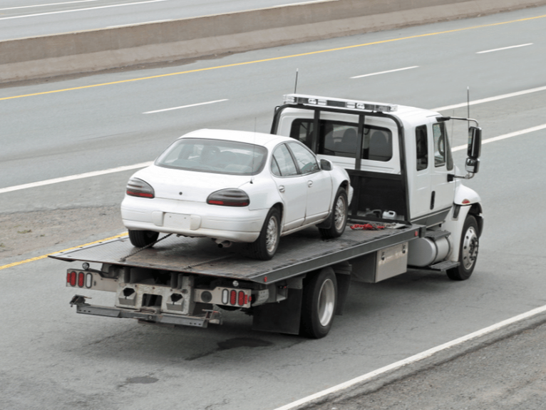 Tow truck driving on a highway in City of Stirling.